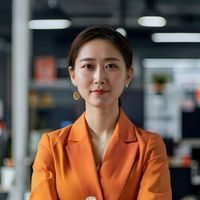 蘑菇视频官网内容运营总监王芳的专业形象照，女性，着橙色系商务装，站在内容审核工作区，神情专注认真，背景整洁明亮